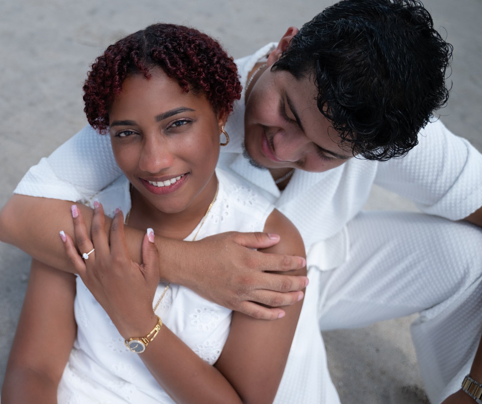 Josue and Yassiel embracing, her engagement ring visible